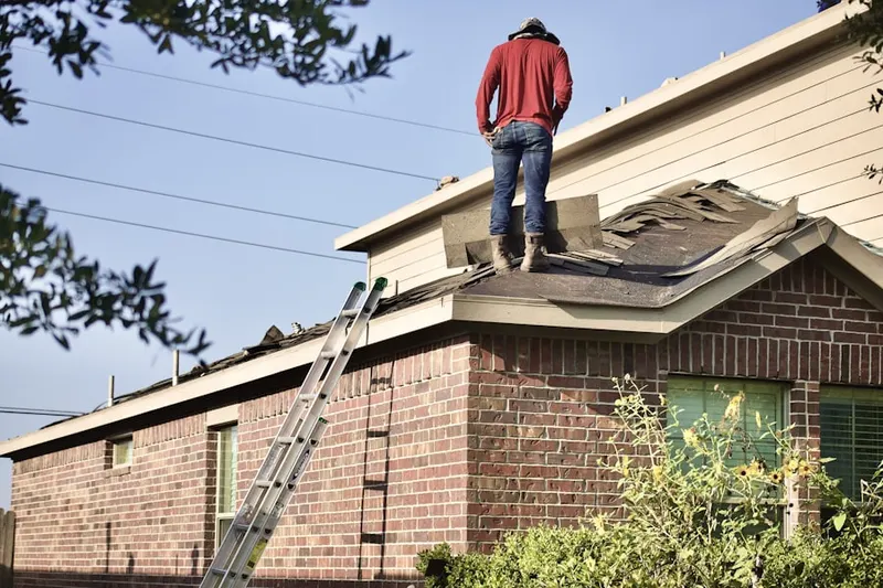 Professional roofer working on a residential roof in Odessa